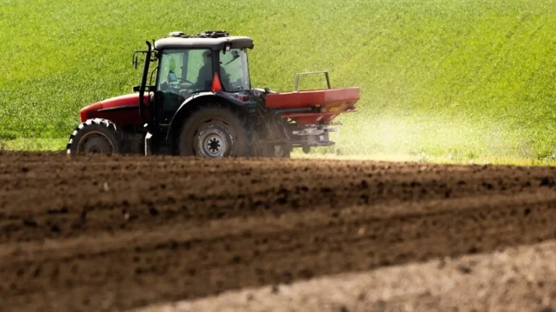 Trator espalhando fertilizantes